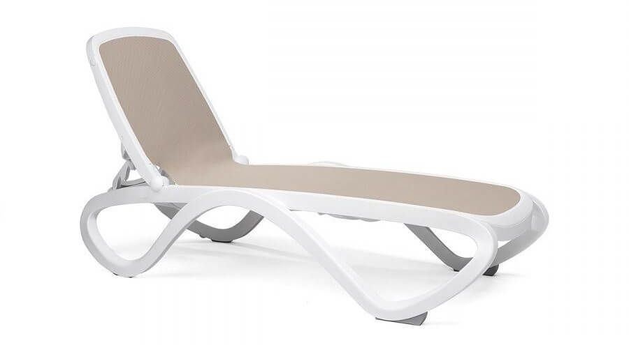 Omega commercial chaise lounge with sculpted white resin frame and breathable tortora sling seat, engineered for long-term durability on resort and poolside decks.